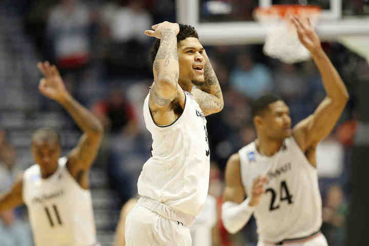 Cincinnati Bearcats guard Jarron Cumberland (center) celebrates an early lead in the first half of a second round NCAA game against the Nevada Wolf Pack at Bridgestone Arena in Nashville.    (Sam Greene / The Cincinnati Enquirer)